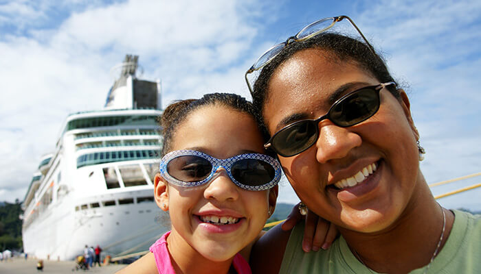 Mother and daughter near a cruise ship