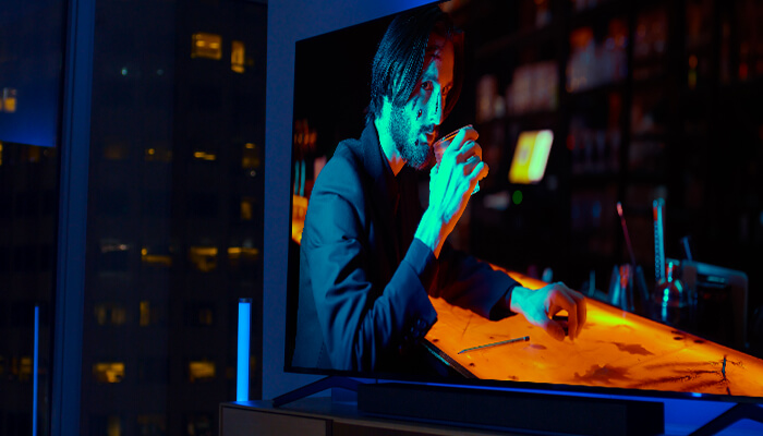 TV screen showing a man at a bar with a drink