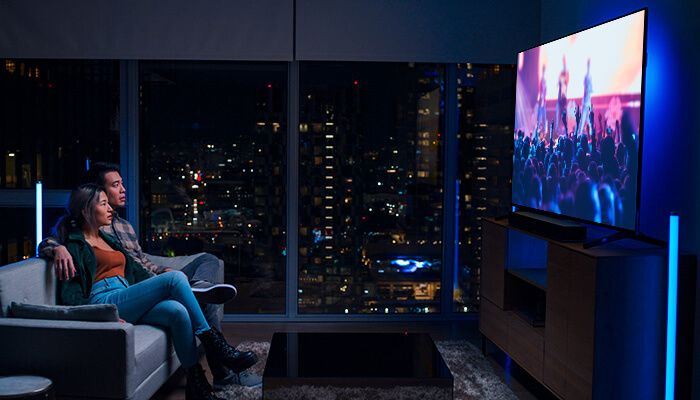 couple watching a movie movie on a large tv