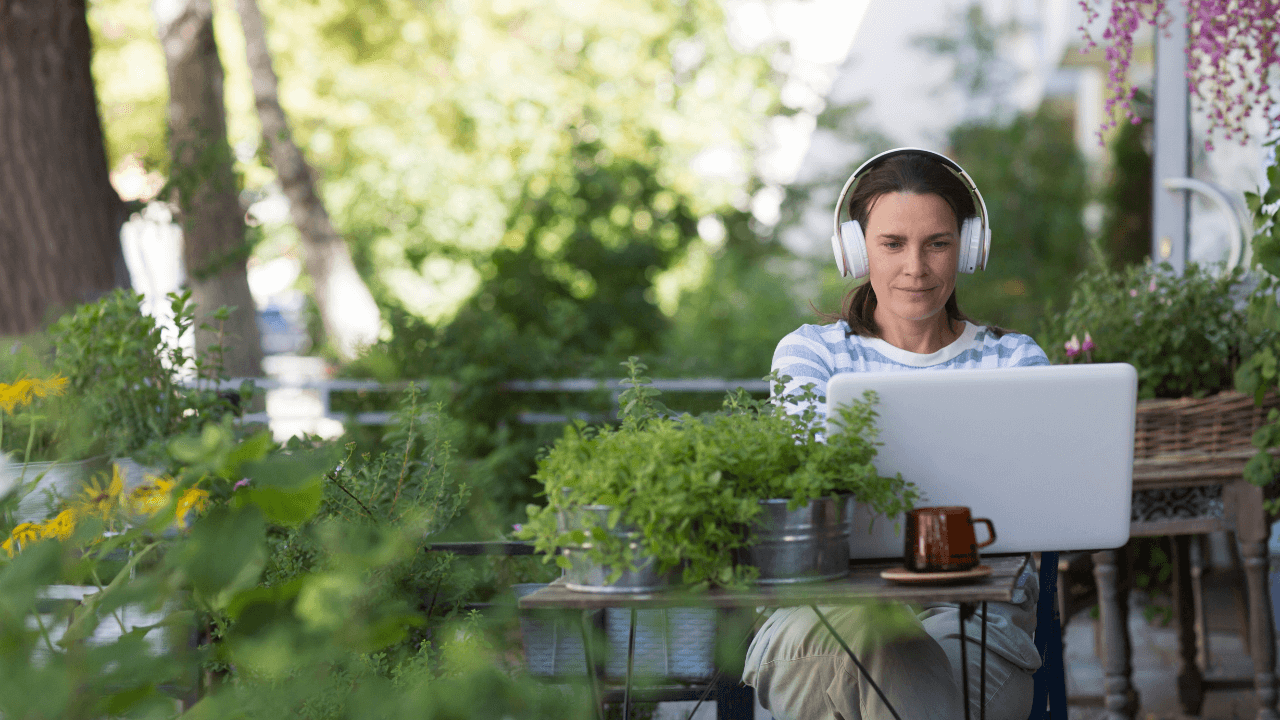 Woman with headphones looking at a laptop